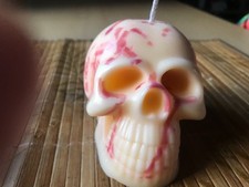 large unscented  red & white scull head candle