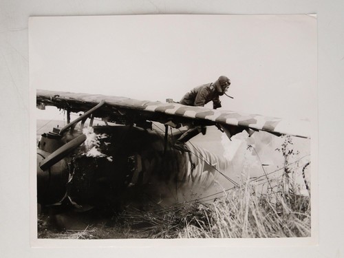 Pilot escaping crashed german - crashed,