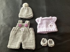 Hand knitted dolls clothes to