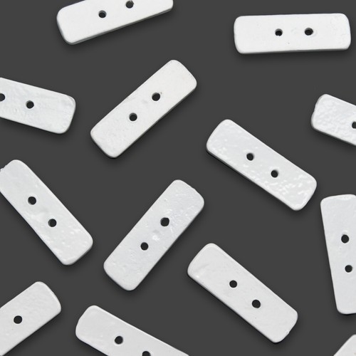 White oblong lead penny - oblong,