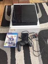 Playstation 4 console with a wireless controller & FIFA23 game