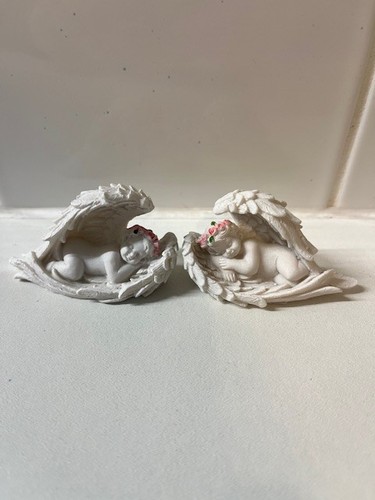 Pair resin cherubs laying - of,