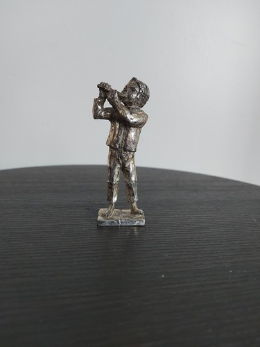 Pewter statue man playing - of, a