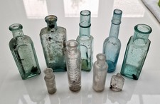 A Collection Of 8 Vintage Dug Glass Bottles