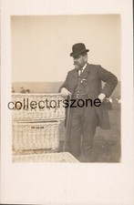 Man Leaning On Bakery Baskets Suit Bowler Hat Real Photo Postcard