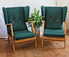 Pair of low mid-century wingback armchairs in green wool