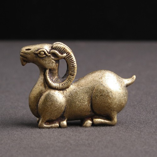 Brass goat statue lying down - statue,