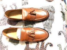 A PAIR OF TASSLE LOAFERS IN