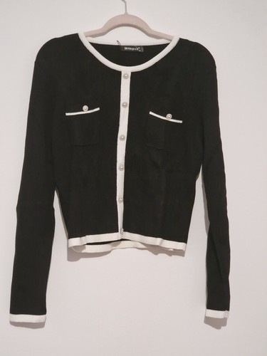Black cardigan features white
