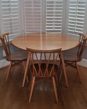 Ecrol round drop leaf dining room table and 4 Ercol Candlestick chairs