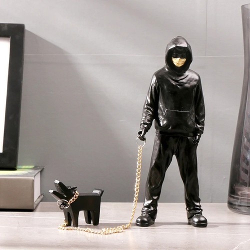 The man leading dog sculpture - the,