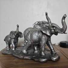 Family of Three  Elephants Standing on a Base