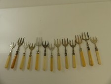 (ref288AI13) 13 Antique silver plated bovine bone handled bread forks