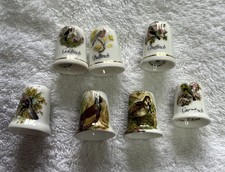 7 Vintage Thimbles Depicting