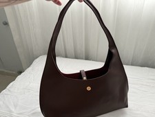 Burgundy Faux Leather Shoulder Bag With Clasp Closure.
