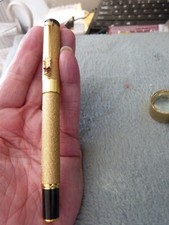 a golden fountain pen never