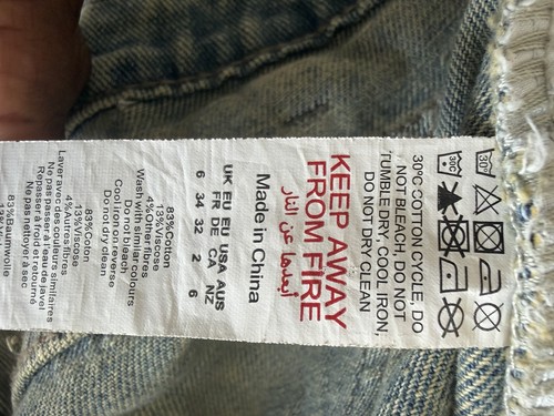 Distressed blue denim jeans