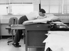 Draughtsman working closely a