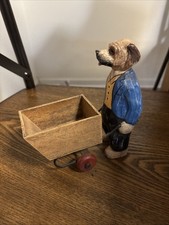Primitive wooden dog pushing