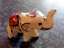 Small painted ceramic elephant figurine 2" tall, unbranded. 