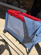 Cosatto Red and Blue Travel Cot On Wheels and Newborn Bassinet Inc Mattress