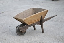 old vintage wooden wheelbarrow with solid rubber wheel