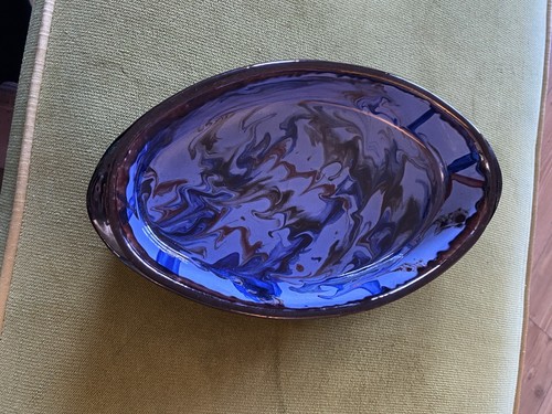 Glazed serving dish featuring - ,
