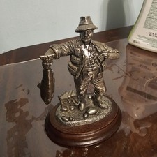 pewter figurine of a fisherman