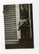 Boy holding toy gun rifle -