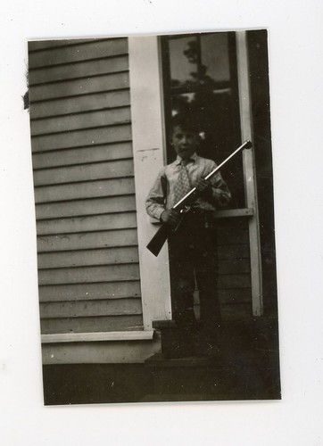 Boy holding toy - rifle,