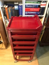 A Solid Red Plastic Six Drawer Home File on Wheels