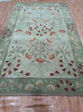 Hand tufted green wool rug for