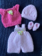 Hand knitted dolls clothes to