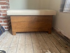 Chunky wooden ottoman with fabric topper