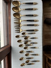 Collection of gold and black coloured Cutlery With Some Marked “Vishnu Siam”