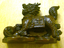 Chinese Foo Dog - Resin brown moulded Figurine with right front paw on ball