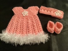 Hand knitted dolls clothes to