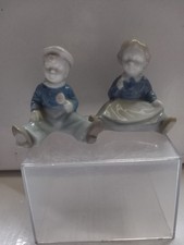 Boy And Girl Both Sitting Down Ornaments