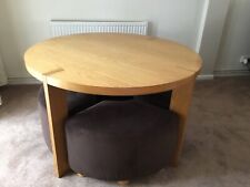 Round Veneer Wood Table & Four Brown Fabric Covered Stowaway Stools Collection