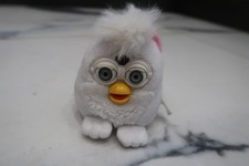 white stuffed owl with pink ears, and facial features made of plastic.