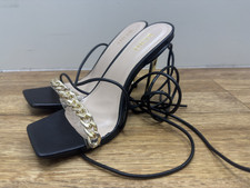 Black strappy high-heeled sandals with gold chain detail by BEBO heels