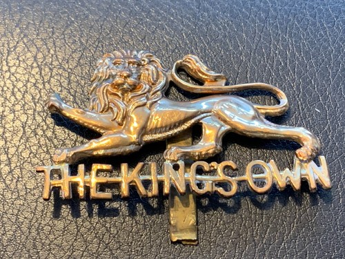 Kings own regiment cap badge - own,