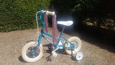 Girls bike Magna Pretty Miss in turquoise with pink tassles. One careful owner!