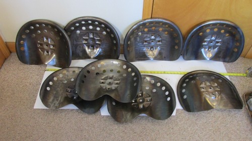 Eight steel tractor seats - steel,