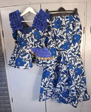 two-piece outfit featuring a peplum top and a skirt 12-14