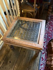 Moroccan-style coffee table. Hardwood, glass, and decorative, iron fretwork.