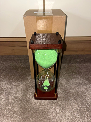 Glass hourglass with - , green