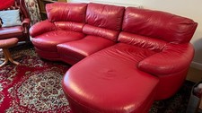 DFS red leather curved sofa/settee with chaise end and rotating seat. 