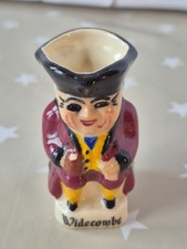 Devonmoor Miniature Toby Jug Wearing A Brown Jacket. Widdecombe Written On Base
