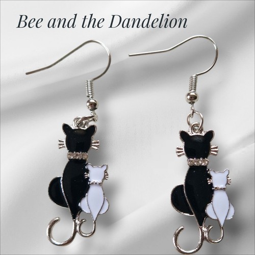 Black cat and white kitten - white,